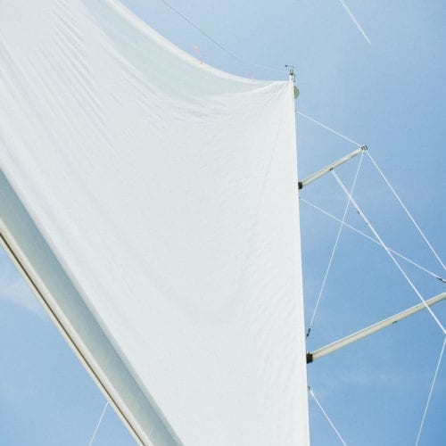 A skyward view of the sail on New Buffalo Sailing Excursions.