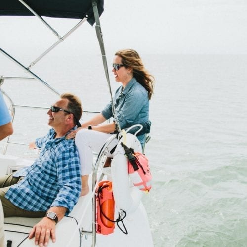 A couple enjoying a cruise with New Buffalo Sailing Excursions on Lake Michigan.