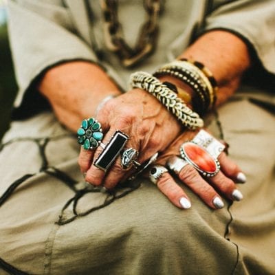 An exotic collection of rings on the hands of an artist at Outsiders Outside Art Fair in Harbert, Michigan.