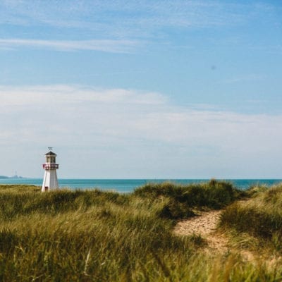 A view of the lighthouse from grassy dunes overlooking Lake Michigan at New Buffalo Beach, Michigan.