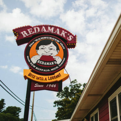 A vintage lighted sign with Redamak's iconic logo in New Buffalo, Michigan.