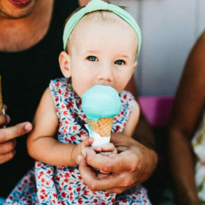 A baby having her first taste of ice cream at Oink's Dutch Treat in New Buffalo, Michigan.