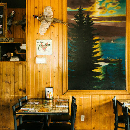 A large vintage painting of a lakeshore scene at Red Arrow Roadhouse in Union Pier, Michigan.