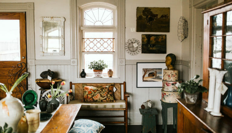 A beautiful vintage window surrounded by art and antiques at Mazet in Three Oaks, Michgian.