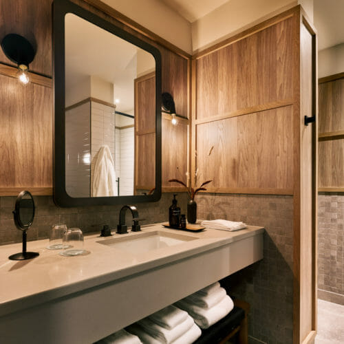 Harbor Grand Hotel Bathroom Plush Towels Mirror Wood Walls