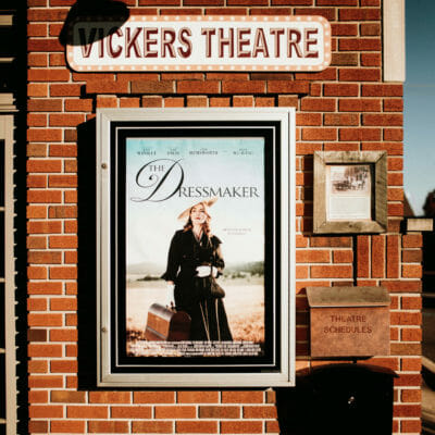 A movie poster on the brick exterior of Vickers Theatre in Three Oaks, Michigan.
