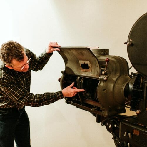 Owner Bill Lindblom shows a vintage reel-to-reel camera at Vickers Theatre in Three Oaks, Michigan.