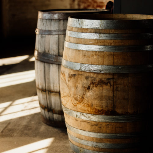 Windowpane shadows and whiskey barrels at Journeyman Distillery in Three Oaks, Michigan.