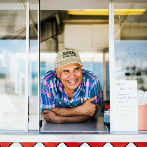 Farmer Bill Shuler smiles as he looks out from the ice cream stand at Shuler Dairy Farms in Baroda, Michigan.