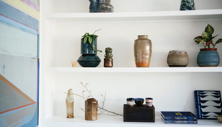 Vintage and contemporary studio ceramics displayed on white shelves at Sojourn in Sawyer, Michigan.
