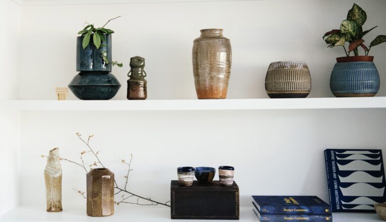 Beautiful contemporary ceramics and books on white shelves at Sojourn in Sawyer, Michigan.