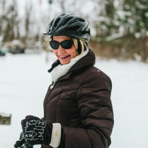A happy woman wearing a bike helmet at Love Creek County Park in southwest Michigan.