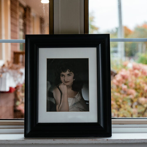 A framed vintage photo of a woman at Harbert Swedish Bakery in Harbert, Michigan.