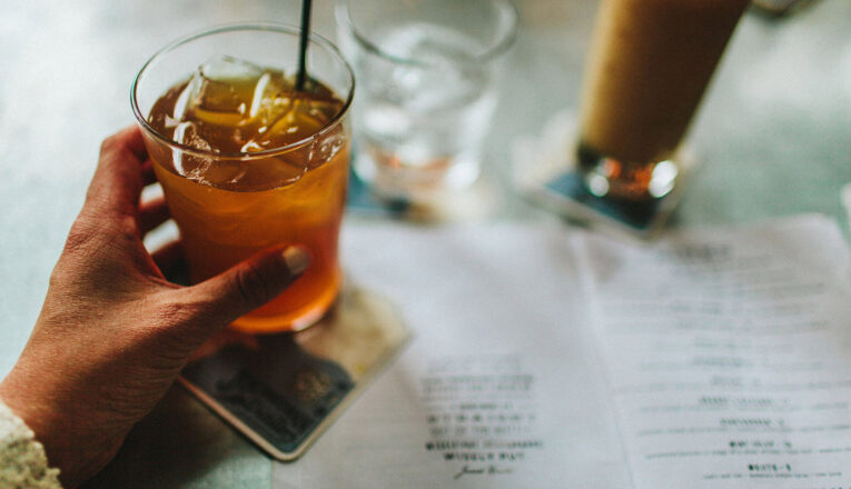 A cocktail in hand at Journeyman Distillery in Three Oaks, Michigan.