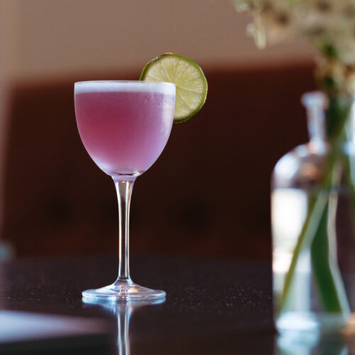 A bright pink cocktail with a lime at Gather in Harbert, Michigan.