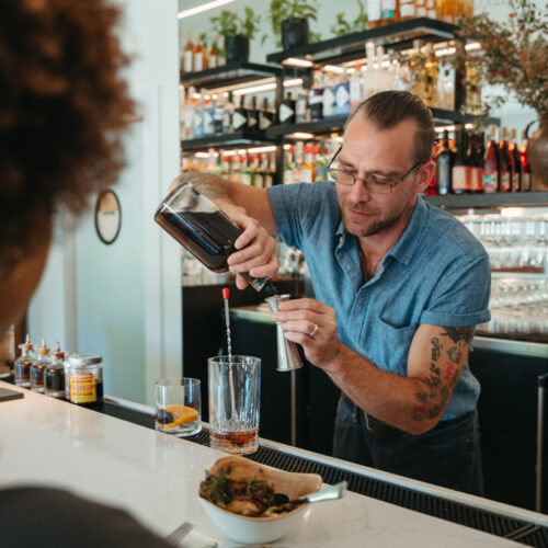 A bartender creating a cocktail at Gather in Harbert, Michigan.