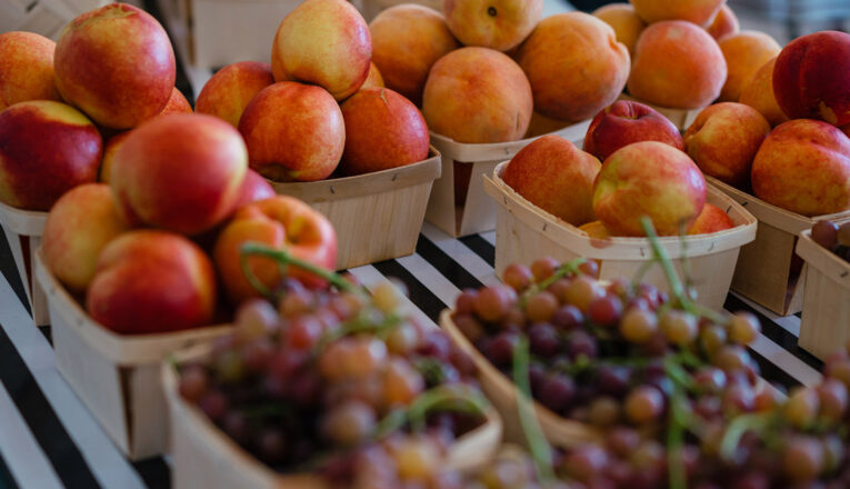 Boxes of fresh apples and grapes on display at the New Buffalo Farmstand in New Buffalo, Michigan.