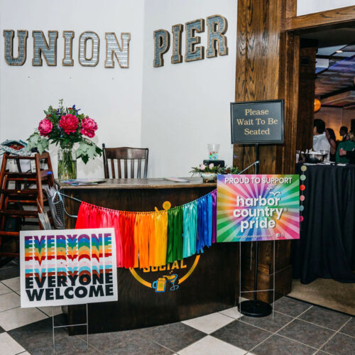 Pride signage and streamers at the entrance of the Harbor Country Pride Prom event in Union Pier, Michigan.
