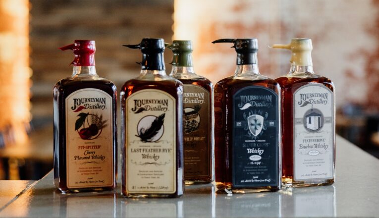 Various spirits lined up for display at Journeyman Distillery in Three Oaks, Michigan.