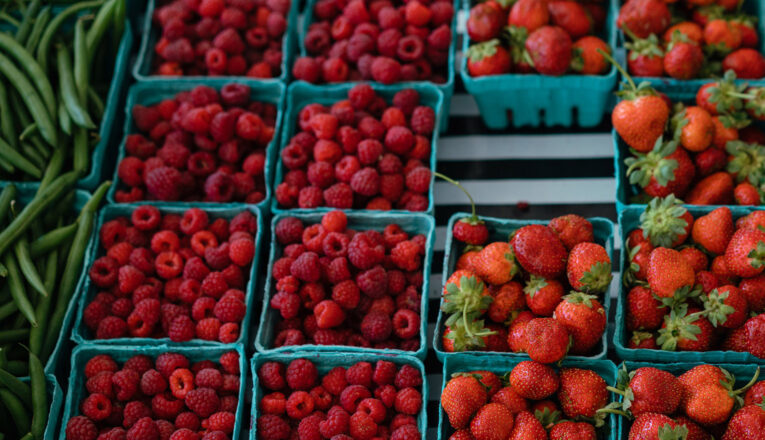 Boxes of fresh green beans, raspberries, and strawberries at the New Buffalo Farmstand in New Buffalo, Michigan.