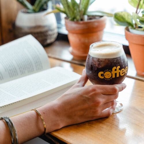 A customer enjoys a book and a Nitro Cold Brew at Infusco Coffee Roasters in Sawyer, Michigan.
