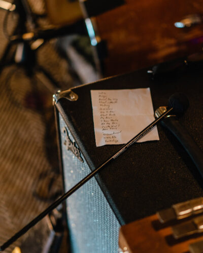 A handwritten set list resting on stage equipment at Journeyman Distillery in Three Oaks, Michigan.