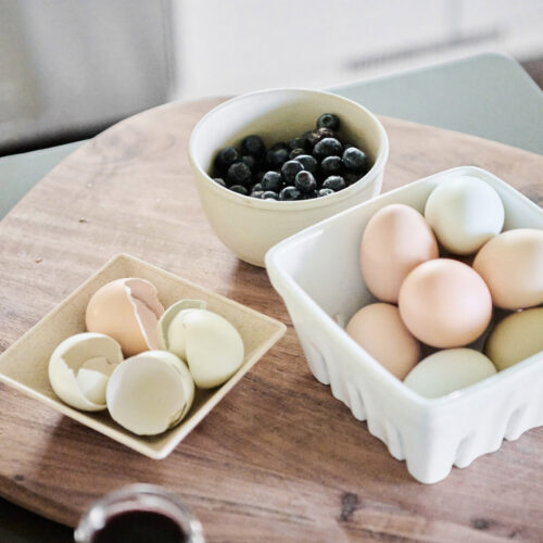 A kitchen detail of farm-fresh eggs and wild blueberries at Wandering Soul Cabin in Sawyer, Michigan.