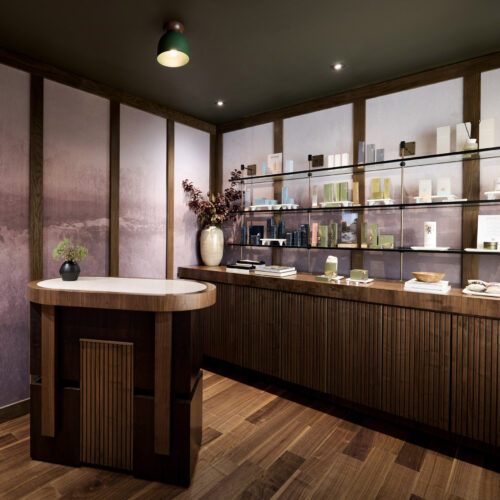 The reception area with dark wood accents and an assortment of products on glass shelving at Foundation Spa in New Buffalo, Michigan.