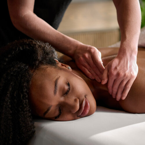 A woman relaxing while receiving a massage treatment at Foundation Spa in New Buffalo, Michigan.