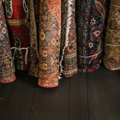 Rolled up rugs leaning against a wall at Mazet in Three Oaks, Michigan.