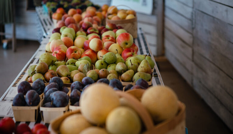 Boxes of fresh apples, pears, and plums on display at the New Buffalo Farmstand in New Buffalo, Michigan.