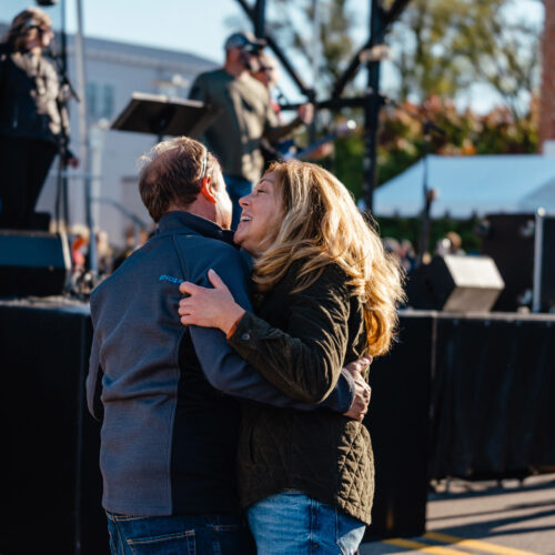 A couple dancing in front of the stage at New Buffalo Harvest and Wine Festival.