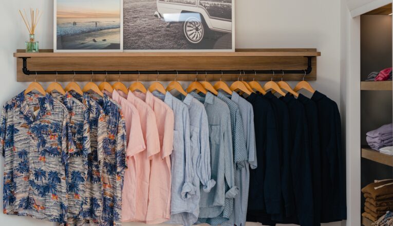 Soft, summery men's button down shirts hung in a row at Shore in New Buffalo, Michigan.