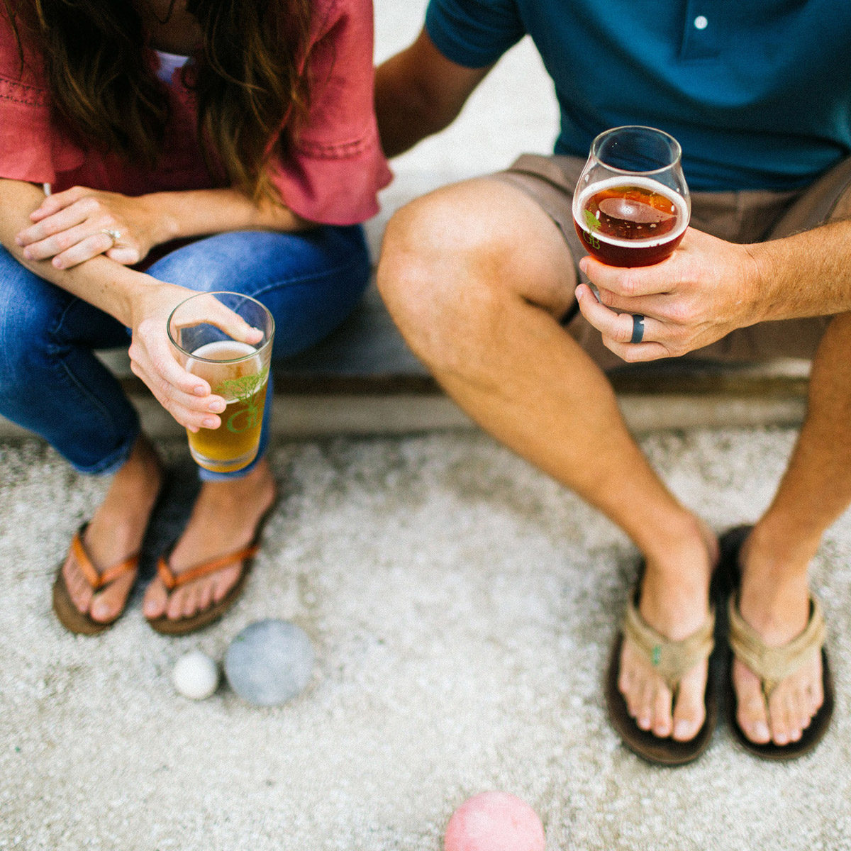 A couple sits on a sandy ledge with beers from Greenbush Brewing in Sawyer, Michigan.