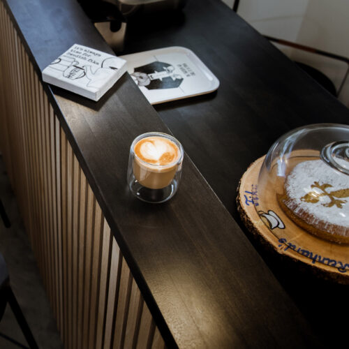 A freshly brewed espresso drink and baked goods for Fika at the counter of Stockholm Objects in Harbert, Michigan.