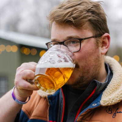 Owner, Ryan Ziarko drinking beer out of a mug at Seedz Brewery in Union Pier, Michigan.