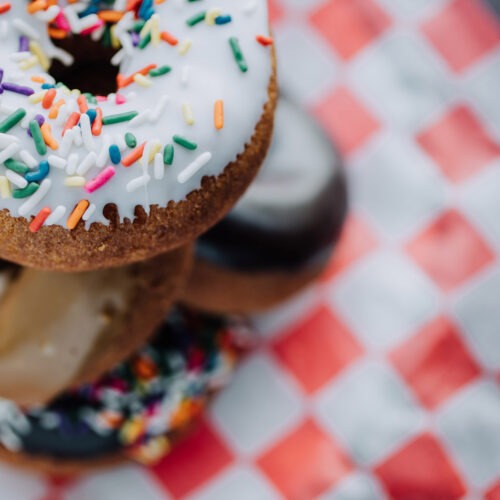 Stacked sprinkle donuts on red checkered paper at Ray & Al's in Galien, Michigan.