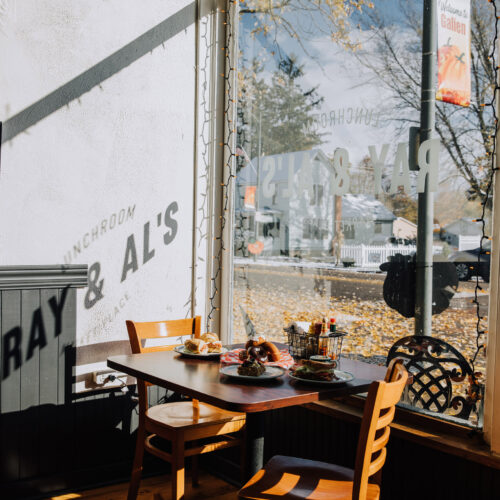 A dining table topped with lunch dishes next to the front window at Ray & Al's in Galien, Michigan.