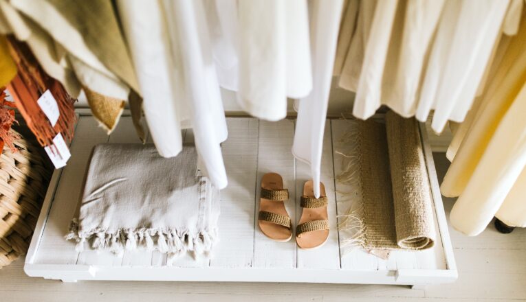 A singe pair of woven sandals among soft, linen clothes and home goods at AP in Lakeside, Michigan