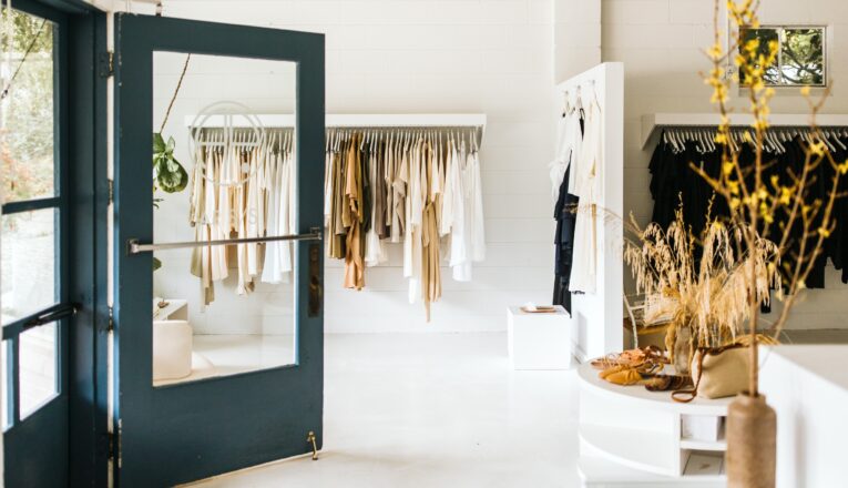 Bright white walls and soft neutral clothing at AP Shop in Lakeside, Michigan.