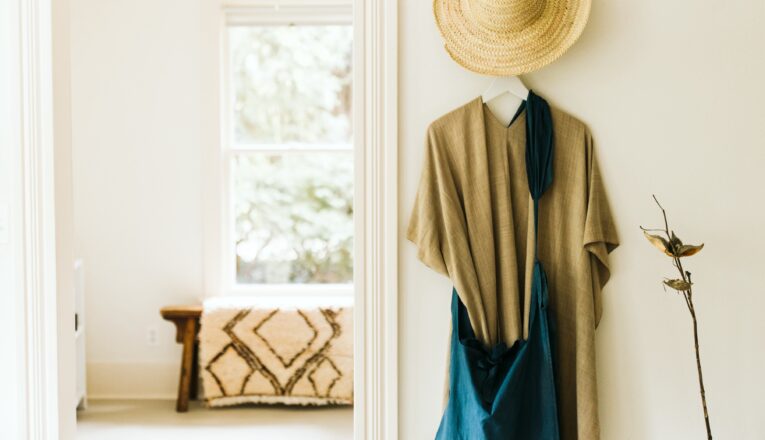 A straw hat, linen tunic, and slouchy teal linen bag at AP Shop in Lakeside, Michigan.