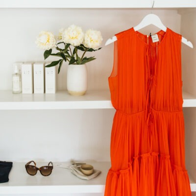 An orange dressing hanging next to accessories at AP in Lakeside, Michigan.