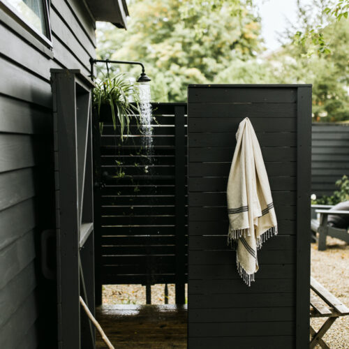 An outdoor shower tucked away in the backyard at Shamrock House in Harbert, Michigan.