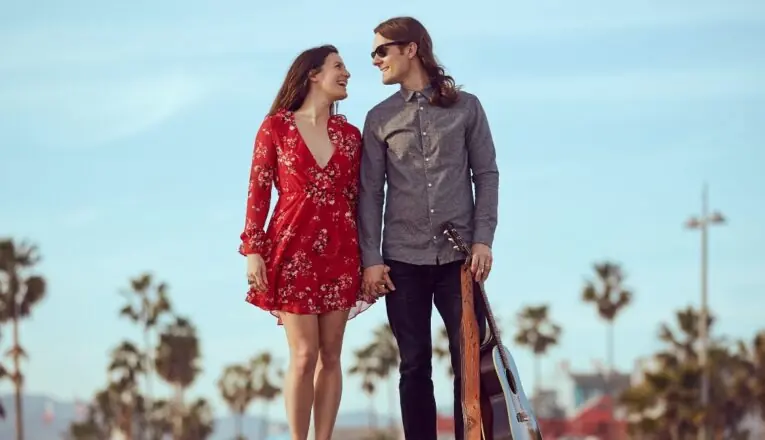 Jillian Speece and Nathanial Hoff hold hands an smile at each other.