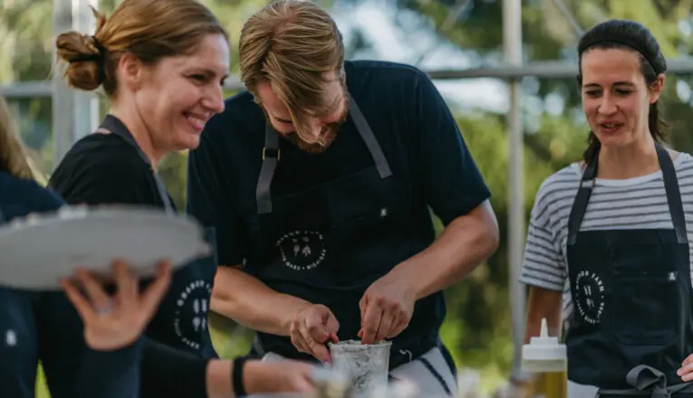 Chef Abra Berens and her team smile as they prepare dinner at Granor Farm in Three Oaks, Michigan.