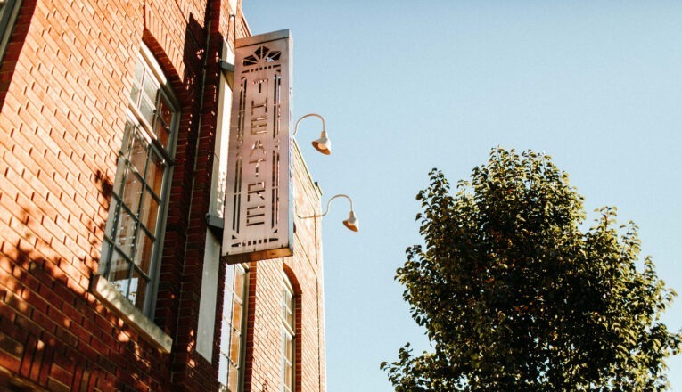 The original brick facade and tall paned windows at Vickers Theatre in Three Oaks, Michigan.