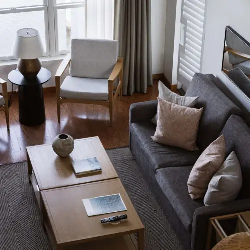 Natural light and Scandinavian modern furniture in the living room of a suite at Marina Grand Resort.