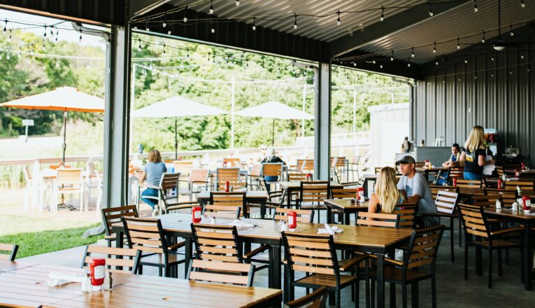 Outdoor seating overlooking the Galien River Marsh Preserve at Ghost Isle Brewery in New Buffalo, Michigan.