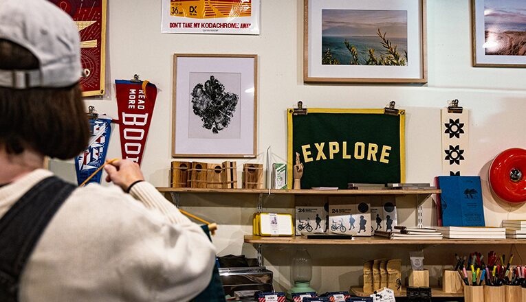 Penants and art hangs on the wall at Handmade Studio in Three Oaks, Michigan