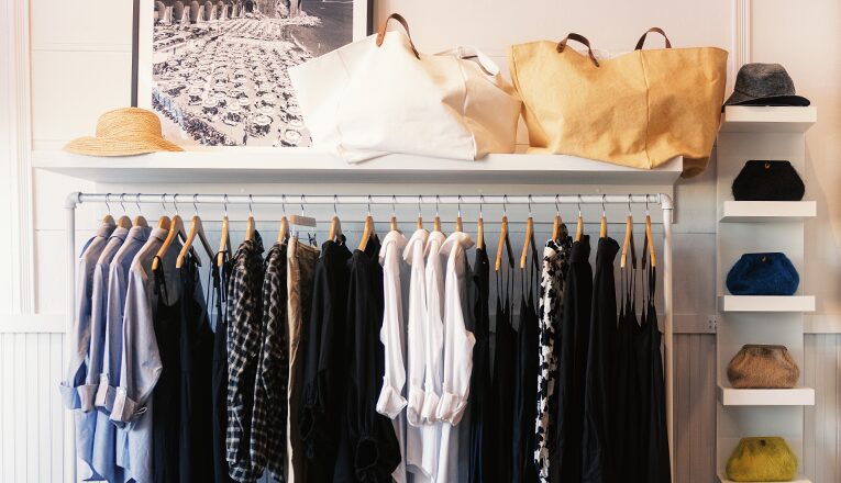 A rack of black, white, and chambray beachy clothes hangs inside Lake Feste in New Buffalo, Michigan